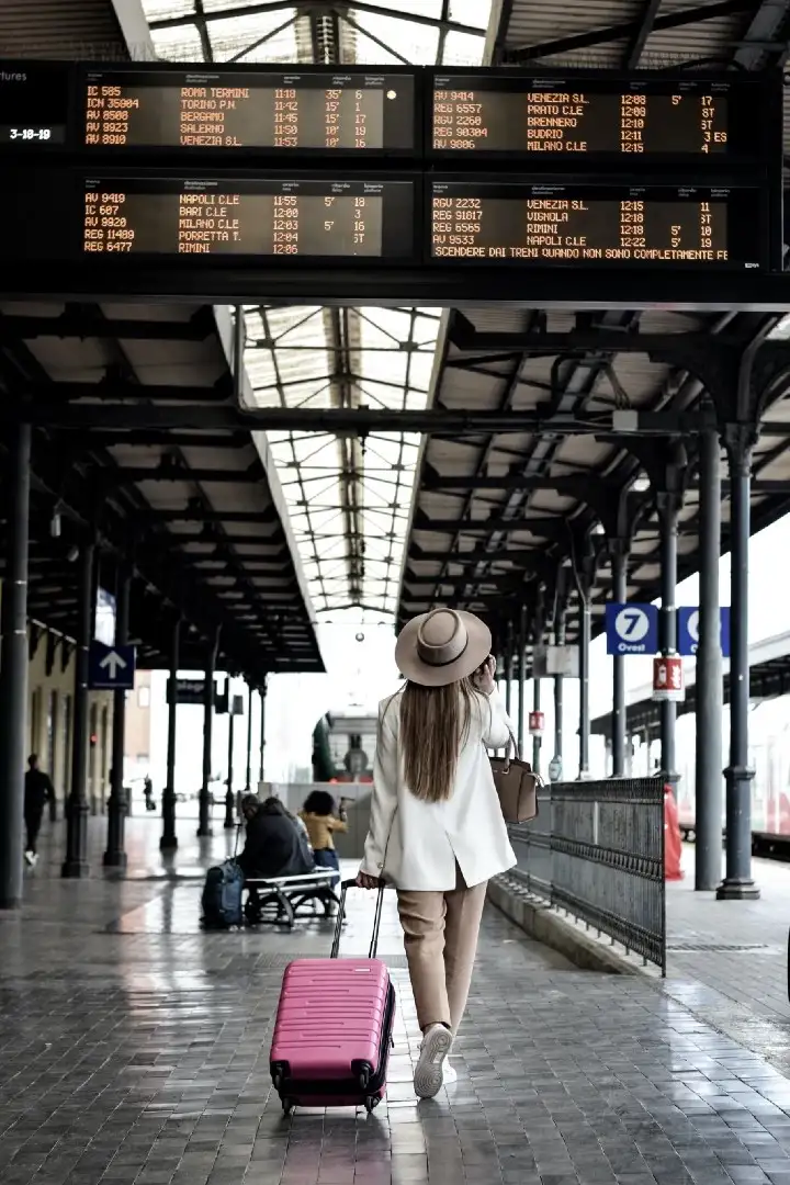 Woman dragging a pink suitcase representing travelling the world and my top 10 cities