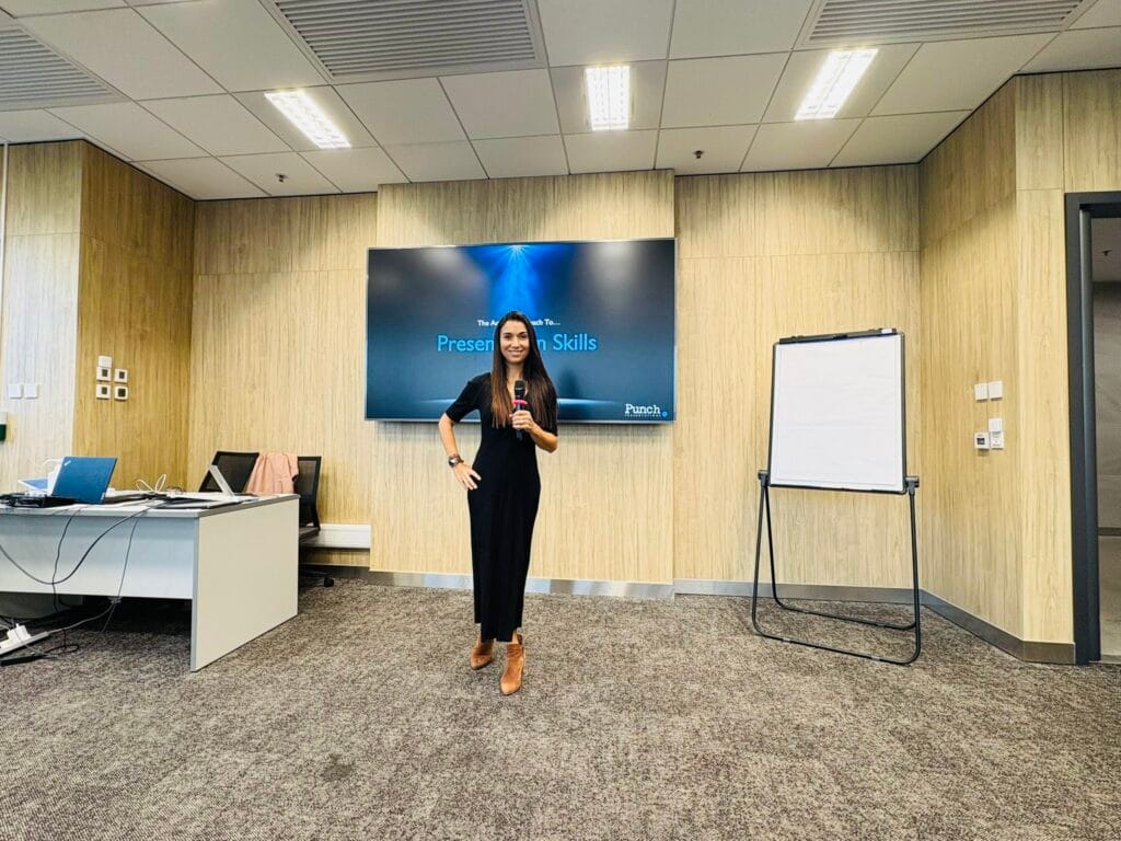 Woman in a black dress with a mic