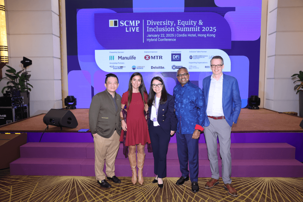 Picture of the panelists and hosts in front of the stage 